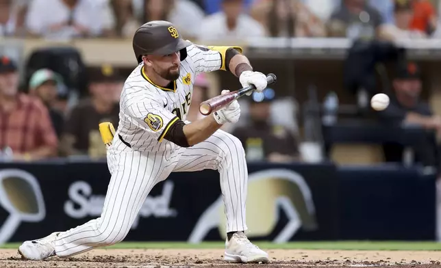 San Diego Padres' Mason McCoy, who was out at first, sacrifice bunts during the fifth inning of a baseball game against the San Francisco Giants, Saturday, Sept. 7, 2024, in San Diego. (AP Photo/Ryan Sun)