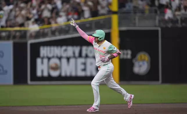 San Diego Padres' Manny Machado celebrates after hitting a home run during the first inning of a baseball game against the San Francisco Giants, Friday, Sept. 6, 2024, in San Diego. (AP Photo/Gregory Bull)