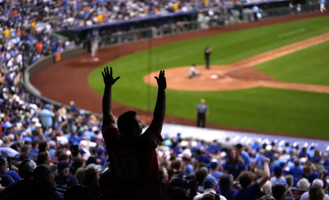 A fan cheers during the seventh inning of a baseball game between the Kansas City Royals and the San Francisco Giants Saturday, Sept. 21, 2024, in Kansas City, Mo. (AP Photo/Charlie Riedel)