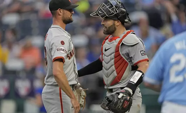 San Francisco Giants relief pitcher Tristan Beck, left, and catcher Curt Casali celebrate after their baseball game against the Kansas City Royals Saturday, Sept. 21, 2024, in Kansas City, Mo. The Giants won 9-0. (AP Photo/Charlie Riedel)