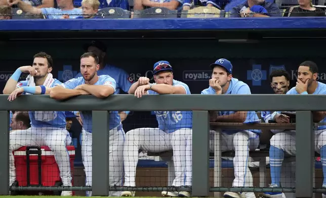 Kansas City Royals players watch from the dugout during the ninth inning of a baseball game against the San Francisco Giants Saturday, Sept. 21, 2024, in Kansas City, Mo. The Giants won 9-0. (AP Photo/Charlie Riedel)