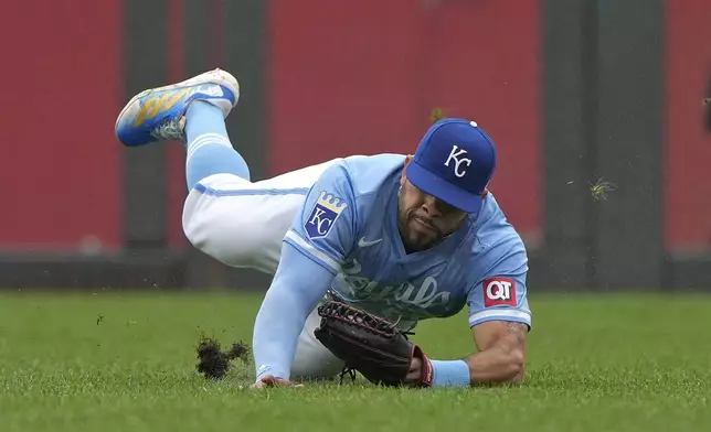 Kansas City Royals left fielder Tommy Pham catches a fly ball for the out on San Francisco Giants' Mike Yastrzemski during the fifth inning of a baseball game Sunday, Sept. 22, 2024, in Kansas City, Mo. (AP Photo/Charlie Riedel)