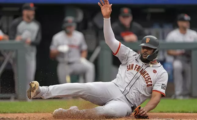 San Francisco Giants' Jerar Encarnacion slides home to score on a triple by Grant McCray during the second inning of a baseball game against the Kansas City Royals Sunday, Sept. 22, 2024, in Kansas City, Mo. (AP Photo/Charlie Riedel)