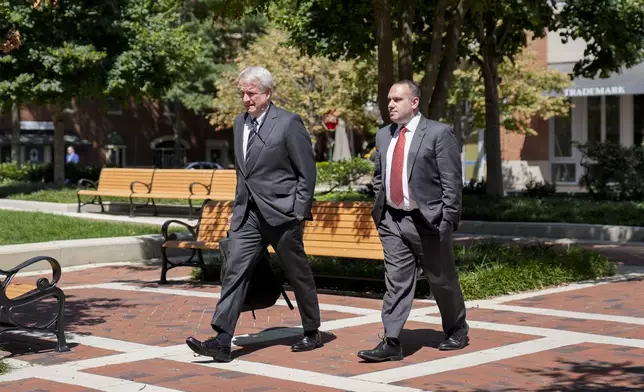 Eric Mahr, left, a lawyer representing Google in the Department of Justice's antitrust case against the tech giant, returns to the U.S. District Court for the Eastern District of Virginia after a lunch break in the trial, Monday, Sept. 9, 2024, in Alexandria, Va. (AP Photo/Stephanie Scarbrough)