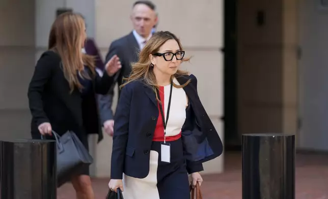 Jeannie Rhee, a lawyer representing Google in the Department of Justice's antitrust case against the tech giant, leaves the U.S. District Court for the Eastern District of Virginia for a break in the trial, Monday, Sept. 9, 2024, in Alexandria, Va. (AP Photo/Stephanie Scarbrough)