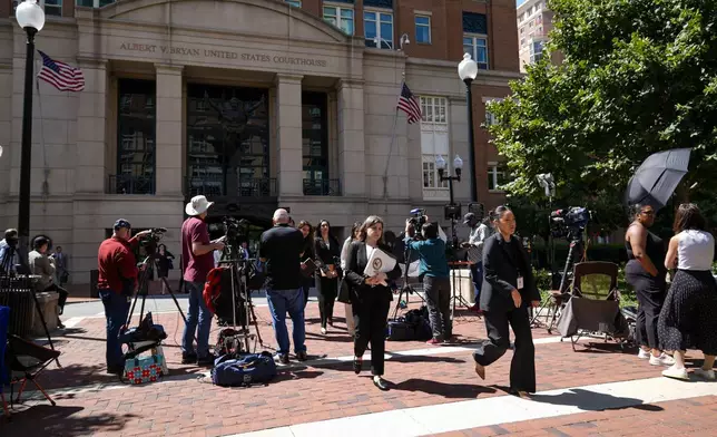 Lawyers and legal assistants leave the U.S. District Court for the Eastern District of Virginia for a lunch break in the Department of Justice's antitrust trial against tech giant Google, Monday, Sept. 9, 2024, in Alexandria, Va. (AP Photo/Stephanie Scarbrough)