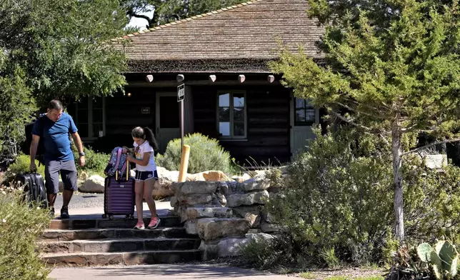 Guests exit Bright Angel Lodge, after visitors won't be able to stay overnight in hotels at Grand Canyon National Park beginning Thursday after a series of breaks in the only pipeline that serves the popular tourist destination, Thursday, Aug. 29, 2024, in Grand Canyon, Ariz. AP Photo/Matt York)