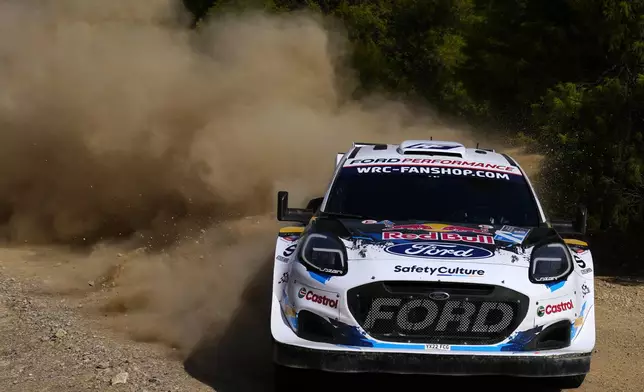 France's driver Adrien Fourmaux and his co-driver Alexandre Coria with Ford Puma Rally1 Hybrid, compete during a special stage of WRC Acropolis Rally in Thiva, some 90 kilometers (56 miles) north of Athens, Greece, Saturday, Sept. 7, 2024. (AP Photo/Thanassis Stavrakis)