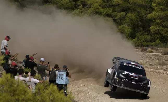 France’s driver Sebastien Ogier and his co-driver Vincent Landais in a Toyota GR Yaris Rally1 Hybrid, compete during a special stage of WRC Acropolis Rally in Thiva, some 90 kilometers (56 miles) north of Athens, Greece, Saturday, Sept. 7, 2024. (AP Photo/Thanassis Stavrakis)