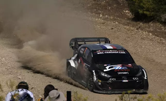 France’s driver Sebastien Ogier and his co-driver Vincent Landais in a Toyota GR Yaris Rally1 Hybrid, compete during a special stage of WRC Acropolis Rally in Thiva, some 90 kilometers (56 miles) north of Athens, Greece, Saturday, Sept. 7, 2024. (AP Photo/Thanassis Stavrakis)