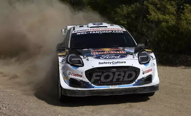 Luxembourg's Gregoire Munster and his Belgian co-driver Louis Louka in a Ford Puma Rally1 Hybrid, compete during a special stage of WRC Acropolis Rally in Thiva, some 90 kilometers (56 miles) north of Athens, Greece, Saturday, Sept. 7, 2024. (AP Photo/Thanassis Stavrakis)