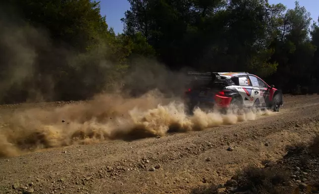 Estonia's driver Ott Tanak and his co-driver Martin Jarveoja with Hyundai i20 N Rally1 Hybrid compete during a special stage of WRC Acropolis Rally in Thiva, some 90 kilometers (56 miles) north of Athens, Greece, Saturday, Sept. 7, 2024. (AP Photo/Thanassis Stavrakis)