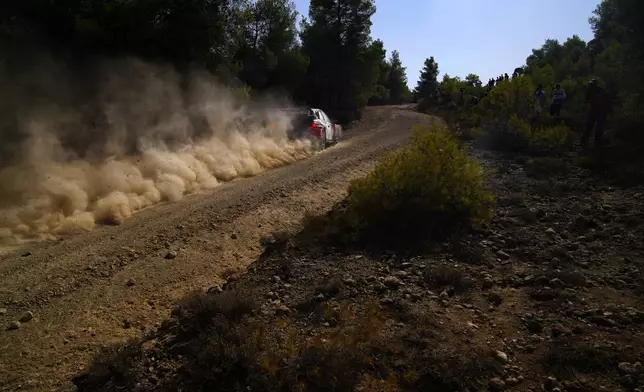 Estonia's driver Ott Tanak and his co-driver Martin Jarveoja with Hyundai i20 N Rally1 Hybrid compete during a special stage of WRC Acropolis Rally in Thiva, some 90 kilometers (56 miles) north of Athens, Greece, Saturday, Sept. 7, 2024. (AP Photo/Thanassis Stavrakis)