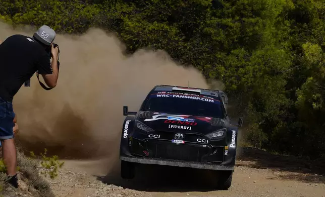 Japan's Takamoto Katsuta and his Irish co-driver Aaron Johnston with Toyota GR Yaris Rally1 Hybrid, compete during a special stage of WRC Acropolis Rally in Thiva, some 90 kilometers (56 miles) north of Athens, Greece, Saturday, Sept. 7, 2024. (AP Photo/Thanassis Stavrakis)