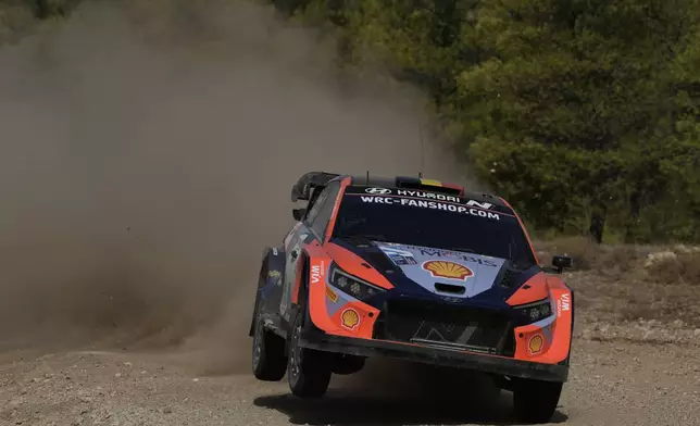 Belgium's Thierry Neuville and his co-driver Martijn Wydaeghe in a Hyundai i20 N Rally1 Hybrid compete during a special stage of WRC Acropolis Rally in Thiva, some 90 kilometers (56 miles) north of Athens, Greece, Saturday, Sept. 7, 2024. (AP Photo/Thanassis Stavrakis)