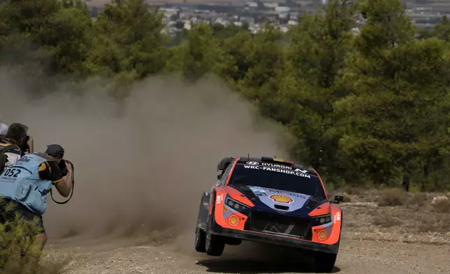 Belgium's Thierry Neuville and his co-driver Martijn Wydaeghe in a Hyundai i20 N Rally1 Hybrid compete during a special stage of WRC Acropolis Rally in Thiva, some 90 kilometers (56 miles) north of Athens, Greece, Saturday, Sept. 7, 2024. (AP Photo/Thanassis Stavrakis)