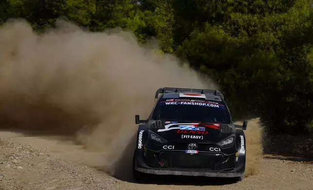 Japan's Takamoto Katsuta and his Irish co-driver Aaron Johnston with Toyota GR Yaris Rally1 Hybrid, compete during a special stage of WRC Acropolis Rally in Thiva, some 90 kilometers (56 miles) north of Athens, Greece, Saturday, Sept. 7, 2024. (AP Photo/Thanassis Stavrakis)