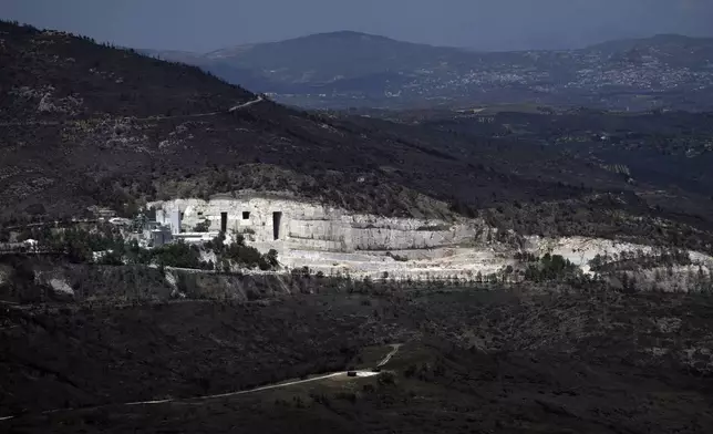 The blackened forests around a marble quarry, which had been burned in a mid-August wildfire, are seen at Dionysos northern suburb of Athens, Thursday, Aug. 22, 2024. (AP Photo/Thanassis Stavrakis)