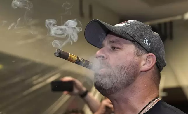 Cleveland Guardians manager Stephen Vogt celebrates winning the American League Central with his team in the clubhouse following a baseball game against the St. Louis Cardinals Saturday, Sept. 21, 2024, in St. Louis. (AP Photo/Jeff Roberson)