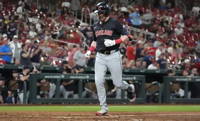 Cleveland Guardians' Lane Thomas arrives home after hitting a solo home run during the eighth inning of a baseball game against the St. Louis Cardinals Friday, Sept. 20, 2024, in St. Louis. (AP Photo/Jeff Roberson)