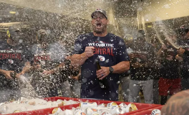 Cleveland Guardians manager Stephen Vogt celebrates in the clubhouse following a baseball game against the St. Louis Cardinals and winning the American League Central Saturday, Sept. 21, 2024, in St. Louis. (AP Photo/Jeff Roberson)