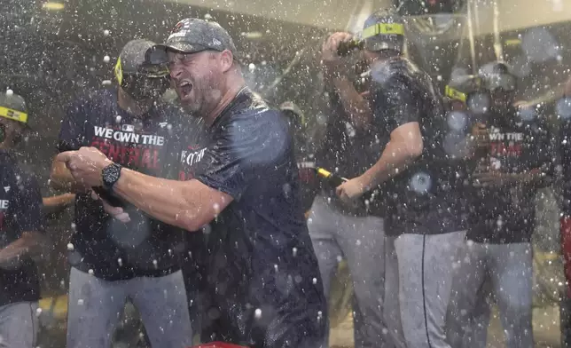 Cleveland Guardians manager Stephen Vogt celebrates with his team in the clubhouse following a baseball game against the St. Louis Cardinals and winning the American League Central Saturday, Sept. 21, 2024, in St. Louis. (AP Photo/Jeff Roberson)