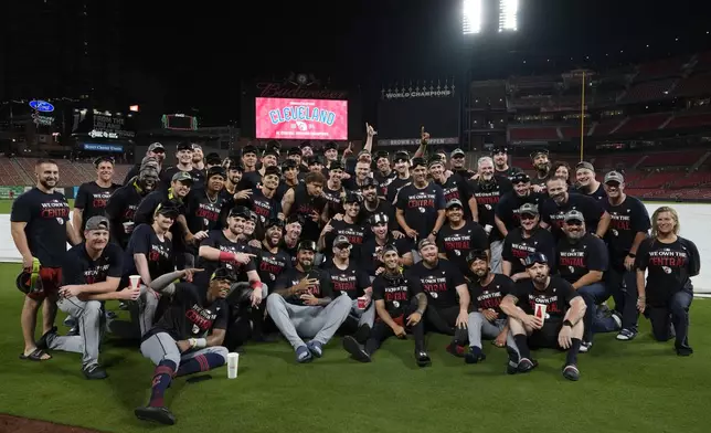 Members of the Cleveland Guardians pose for a group photo after winning the American League Central following a baseball game against the St. Louis Cardinals Saturday, Sept. 21, 2024, in St. Louis. (AP Photo/Jeff Roberson)