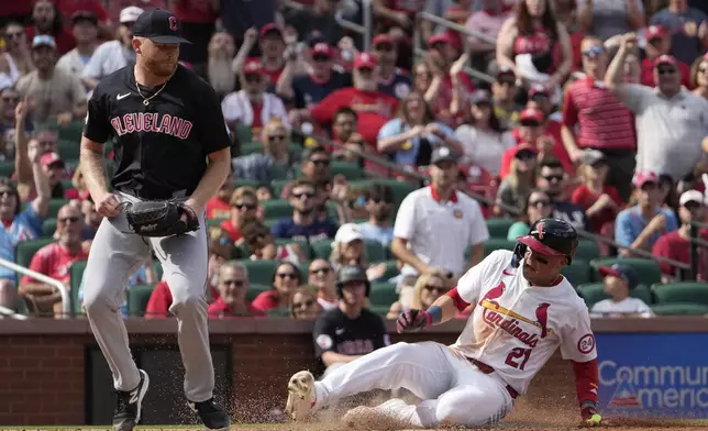 St. Louis Cardinals' Lars Nootbaar (21) scores on a wild pitch by Cleveland Guardians relief pitcher Andrew Walters, left, during the seventh inning of a baseball game Sunday, Sept. 22, 2024, in St. Louis. (AP Photo/Jeff Roberson)