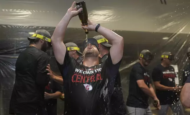 Cleveland Guardians manager Stephen Vogt celebrates in the clubhouse following a baseball game against the St. Louis Cardinals and winning the American League Central Saturday, Sept. 21, 2024, in St. Louis. (AP Photo/Jeff Roberson)