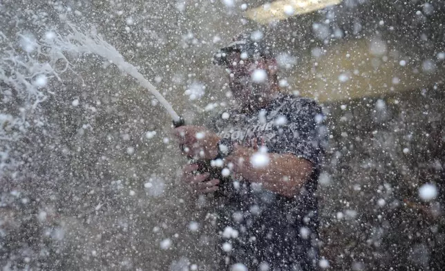 Cleveland Guardians manager Stephen Vogt celebrates in the clubhouse following a baseball game against the St. Louis Cardinals and winning the American League Central Saturday, Sept. 21, 2024, in St. Louis. (AP Photo/Jeff Roberson)