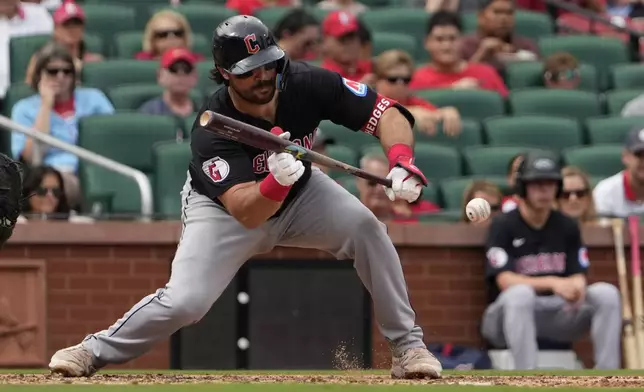 Cleveland Guardians' Austin Hedges lays down a sacrifice bunt to score Myles Straw during the sixth inning of a baseball game against the St. Louis Cardinals Sunday, Sept. 22, 2024, in St. Louis. (AP Photo/Jeff Roberson)