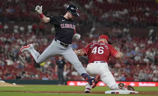 Cleveland Guardians' Lane Thomas, left, grounds out as St. Louis Cardinals first baseman Paul Goldschmidt handles the throw during the fifth inning of a baseball game Friday, Sept. 20, 2024, in St. Louis. (AP Photo/Jeff Roberson)