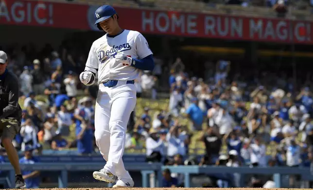 Los Angeles Dodgers' Shohei Ohtani scores after hitting a solo home run during the fifth inning of a baseball game against the Cleveland Guardians, Sunday, Sept. 8, 2024, in Los Angeles. (AP Photo/Mark J. Terrill)