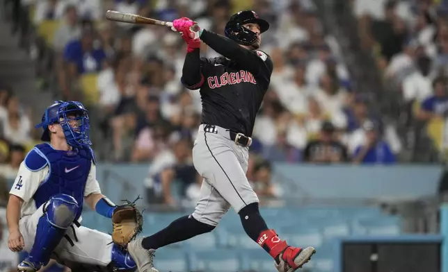 Cleveland Guardians' Andrés Giménez hits a home run during the sixth inning of a baseball game against the Los Angeles Dodgers in Los Angeles, Friday, Sept. 6, 2024. Brayan Rocchio also scored. (AP Photo/Ashley Landis)