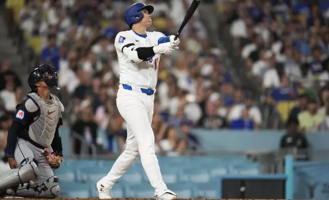 Los Angeles Dodgers designated hitter Shohei Ohtani (17) hits a home run during the sixth inning of a baseball game against the Cleveland Guardians in Los Angeles, Friday, Sept. 6, 2024. (AP Photo/Ashley Landis)