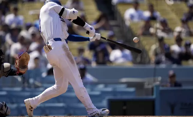 Los Angeles Dodgers' Shohei Ohtani hits a solo home run during the fifth inning of a baseball game against the Cleveland Guardians, Sunday, Sept. 8, 2024, in Los Angeles. (AP Photo/Mark J. Terrill)