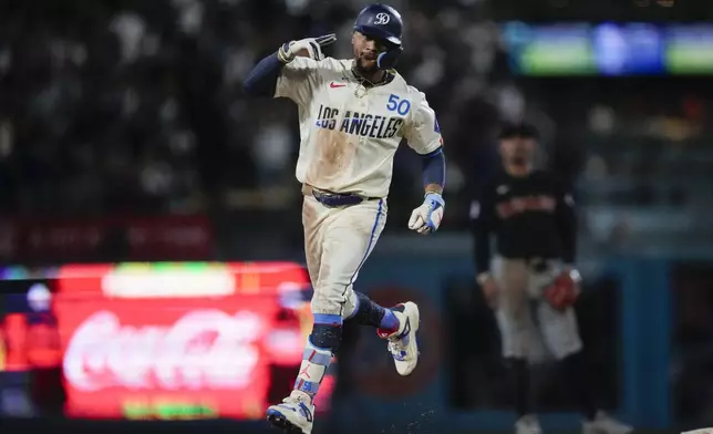 Los Angeles Dodgers' Mookie Betts celebrates after hitting a home run during the fourth inning of a baseball game against the Cleveland Guardians in Los Angeles, Saturday, Sept. 7, 2024. (AP Photo/Ashley Landis)