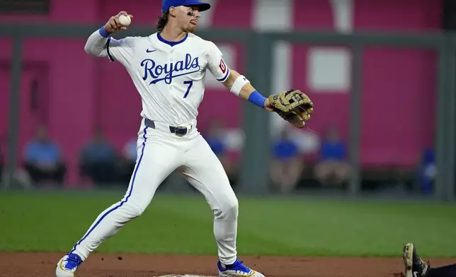 Kansas City Royals shortstop Bobby Witt Jr. throws to first for the double play hit into by Cleveland Guardians' Kyle Manzardo after forcing Will Brennan out at second during the fourth inning of a baseball game Wednesday, Sept. 4, 2024, in Kansas City, Mo. (AP Photo/Charlie Riedel)