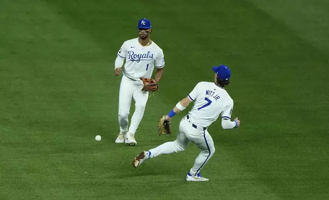 A fly ball single falls between Kansas City Royals shortstop Bobby Witt Jr. (7) and left fielder MJ Melendez (1) during the seventh inning of a baseball game Wednesday, Sept. 4, 2024, in Kansas City, Mo. (AP Photo/Charlie Riedel)