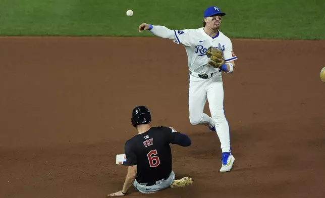 Kansas City Royals shortstop Bobby Witt Jr. throws to first for the double play hit into by Cleveland Guardians' Will Brennan after forcing David Fry (6) out at second during the seventh inning of a baseball game Wednesday, Sept. 4, 2024, in Kansas City, Mo. (AP Photo/Charlie Riedel)