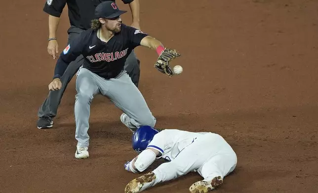 Kansas City Royals' Bobby Witt Jr. beats the tag at second by Cleveland Guardians shortstop Daniel Schneemann after hitting a double during the seventh inning of a baseball game Wednesday, Sept. 4, 2024, in Kansas City, Mo. (AP Photo/Charlie Riedel)