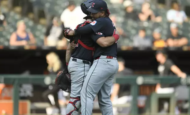 Cleveland Guardians closing pitcher Emmanuel Clase, right, celebrates with catcher Austin Hedges, after defeating the Chicago White Sox in a baseball game in Chicago, Wednesday, Sept. 11, 2024. (AP Photo/Paul Beaty)