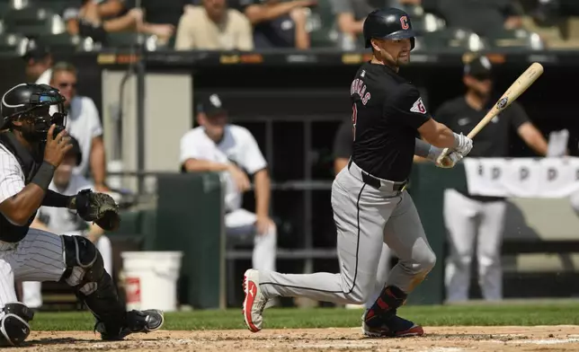 Cleveland Guardians' Lane Thomas watches his 2 RBI single during the third inning of a baseball game against the Chicago White Sox in Chicago, Wednesday, Sept. 11, 2024. (AP Photo/Paul Beaty)