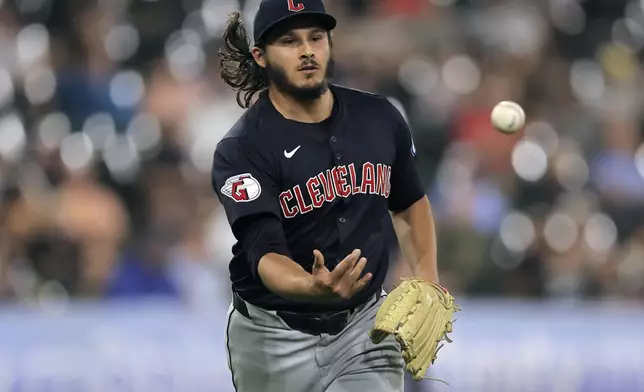 Cleveland Guardians relief pitcher Eli Morgan flips the ball to first base for an out during the fifth inning of a baseball game against the Chicago White Sox, Tuesday, Sept. 10, 2024, in Chicago. (AP Photo/Melissa Tamez)