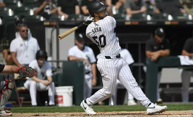 Chicago White Sox's Lenyn Sosa watches his RBI single during the third inning of a baseball game against the Cleveland Guardians in Chicago, Wednesday, Sept. 11, 2024. (AP Photo/Paul Beaty)