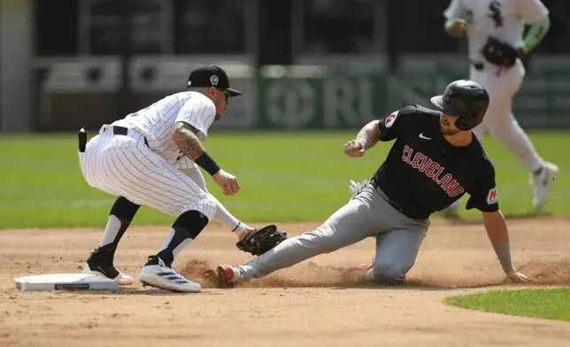 Cleveland Guardians' Lane Thomas, right, is tagged out at second base while trying to steal by Chicago White Sox shortstop Jake Amaya, left, during the first inning of a baseball game in Chicago, Wednesday, Sept. 11, 2024. (AP Photo/Paul Beaty)