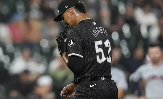 Chicago White Sox pitcher Jairo Iriarte bites his glove after being removed from the mound by interim manager Grady Sizemore during the fifth inning of a baseball game Monday, Sept. 9, 2024, in Chicago. (AP Photo/Erin Hooley)