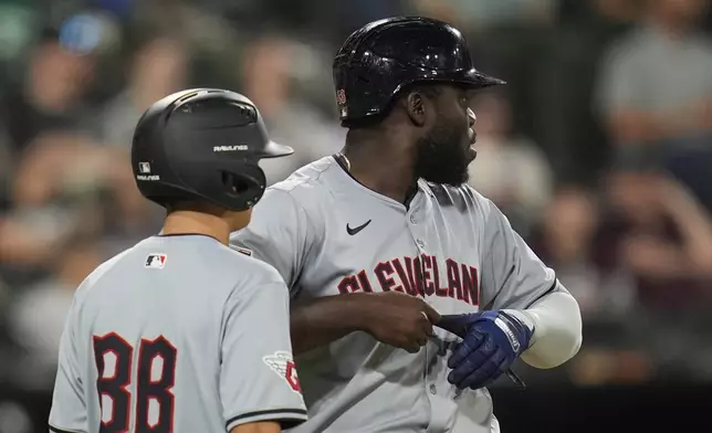 Cleveland Guardians' Jhonkensy Noel removes his glove after Chicago White Sox pitcher Jairo Iriarte walked him, forcing in a run by Steven Kwan, during the fifth inning of a baseball game Monday, Sept. 9, 2024, in Chicago. (AP Photo/Erin Hooley)