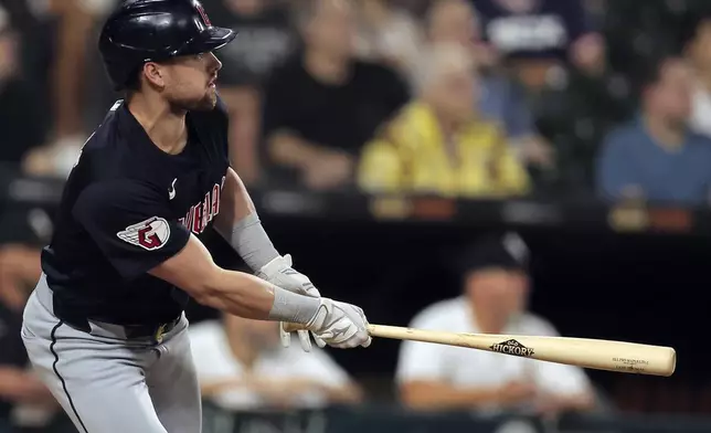 Cleveland Guardians' Lane Thomas watches his three-run home run during the sixth inning of a baseball game against the Chicago White Sox, Tuesday, Sept. 10, 2024, in Chicago. (AP Photo/Melissa Tamez)