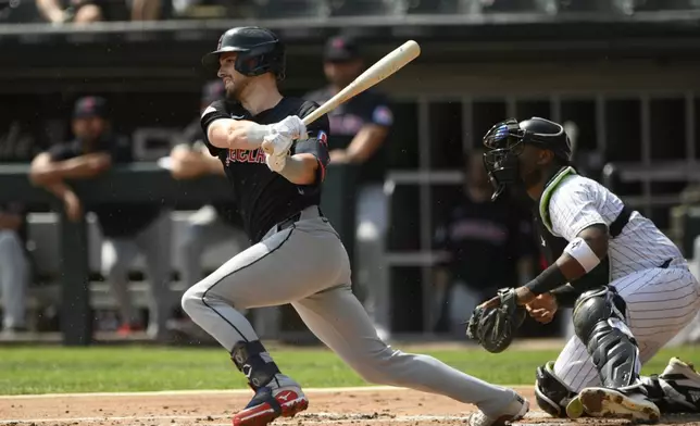 Cleveland Guardians' Lane Thomas watches his 2 RBI single during the first inning of a baseball game against the Chicago White Sox in Chicago, Wednesday, Sept. 11, 2024. (AP Photo/Paul Beaty)